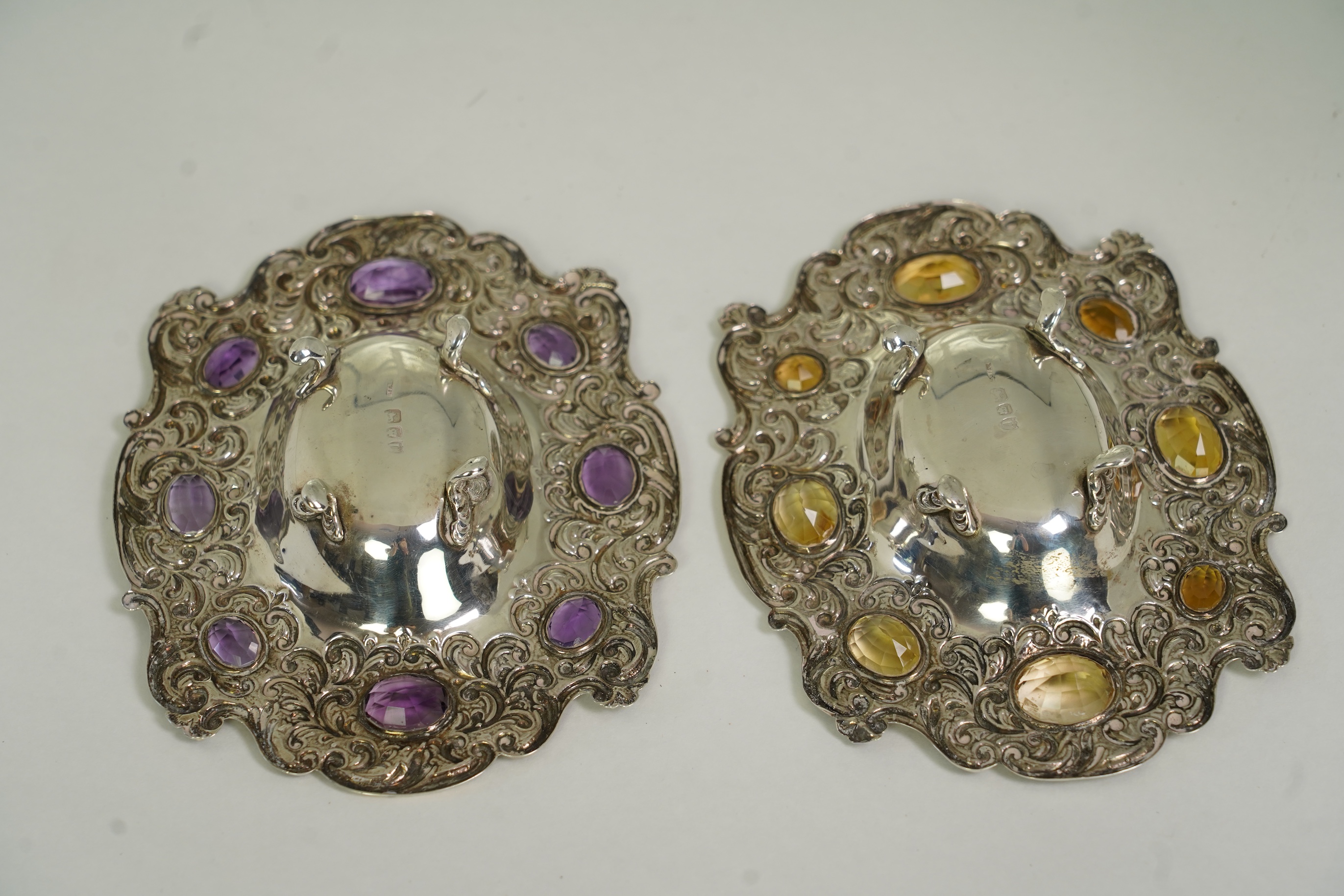 Two unusual late Victorian repousse silver dishes, by Daniel & John Welby, one border inset with eight oval cut amethysts, the other with eight oval cut citrines